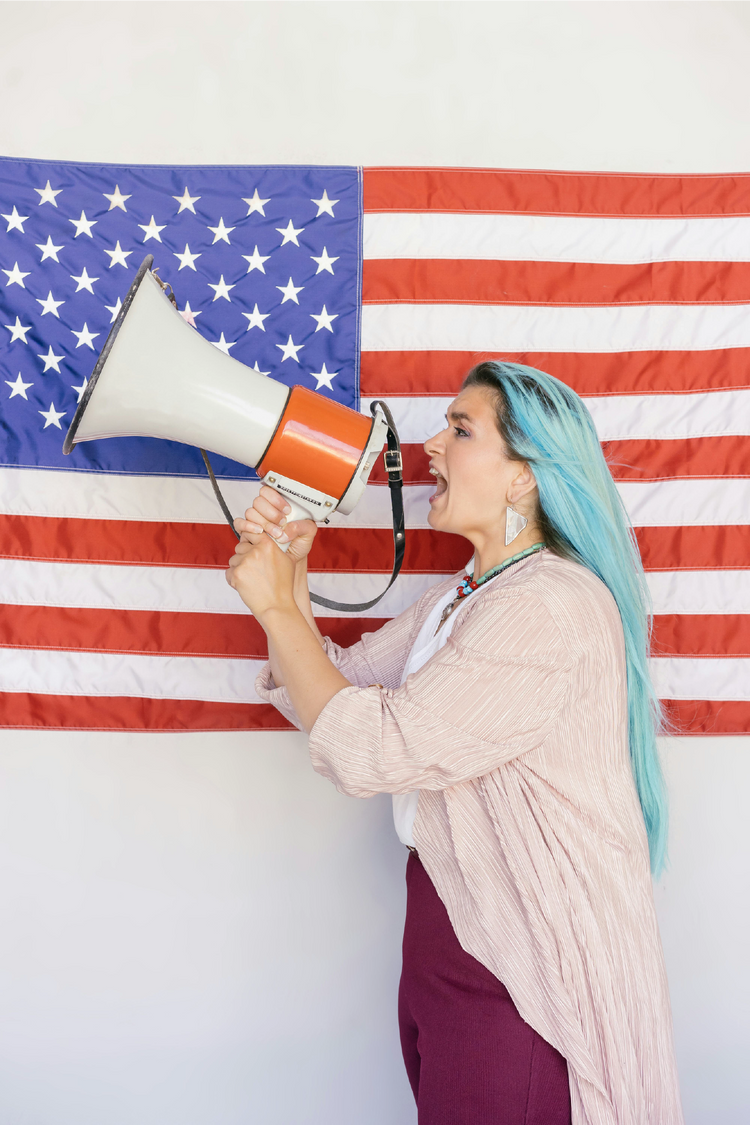 A woman shouting into a loudspeaker 