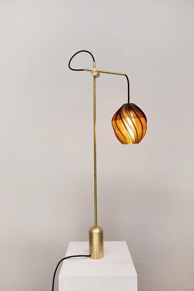 issey lamp table with bronze base, light on